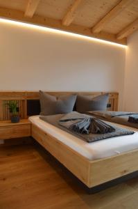 two beds in a room with wooden ceilings at Chalet Groissenbach in Reit im Winkl
