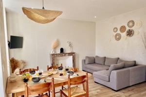 ein Wohnzimmer mit einem Tisch und einem Sofa in der Unterkunft Cosy ANELA in Saint-Claude