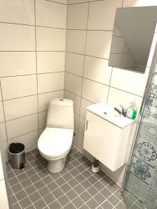 a bathroom with a toilet and a sink at Studio 3 in Landskrona