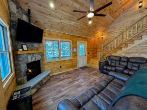 a living room with a couch and a fireplace at 31R Brand new log home on quiet side street in Bethlehem, close to Main Street! 20 min to skiing in Bethlehem