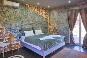 a bedroom with a giraffe wallpaper and a bed at Anna Studios in Marathias +87 photos