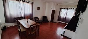 a dining room with a wooden table and chairs at Casa Bordó Villa Allende in Villa Allende