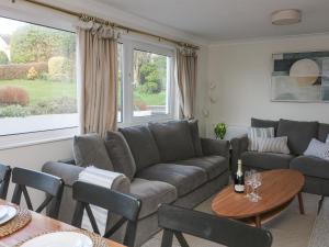 a living room with a couch and a table at 8 Little Hill in Salcombe