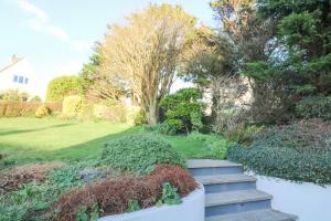 a garden with stairs leading to a yard at 8 Little Hill in Salcombe