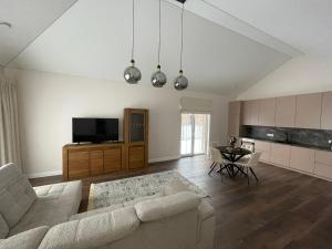 a living room with a couch and a table at MA apartments in Mažeikiai