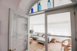 a living room with a couch and a glass door at Casa La Martina Frigiliana in Frigiliana