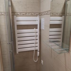 a bathroom with a phone and a glass shelf at Mini apart Žvėrynas in Vilnius
