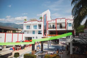 a large white building with a pool and a green slide at Bora Bora Adults only in Melgar