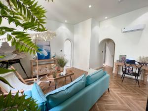 a living room with a blue couch and a table at Tiny House Phu Quoc in Phú Quốc