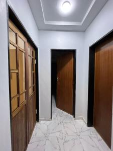 an empty hallway with two doors and a tile floor at Résidence meublée in Ouagadougou