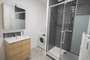 a bathroom with a sink and a washing machine at Equipped apartment premium location in Lille