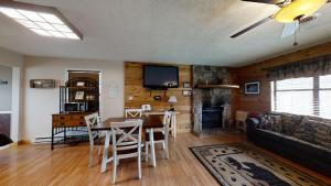 a living room with a table and a fireplace at Heaven's Door in Pigeon Forge