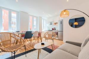 a living room with a couch and chairs and a table at Bright 3-bedroom 2-bathroom flat in Lille