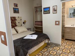 a small bedroom with a bed and a sink at LA CASA MIRADOR DE ÉCIJA in Écija