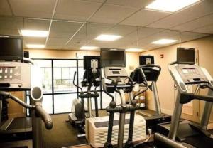 a gym with several treadmills and elliptical machines at Chester Inn & Suites in Sharonville