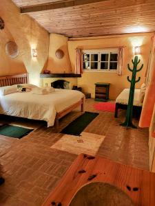 a bedroom with two beds and a cactus in it at Champagny Pousada in Santo Antônio do Pinhal