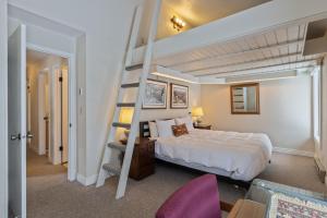 a bedroom with a bed and a spiral staircase at Wister A in Jackson
