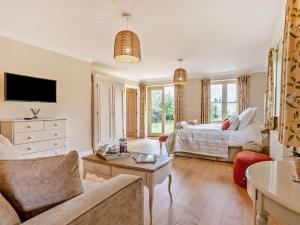 a living room with a bed and a couch at 1 Bed in Ringwood 93169 in Ibsley