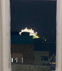 a view of a building at night from a window at Apartamento próximo da Praia in Vila Velha