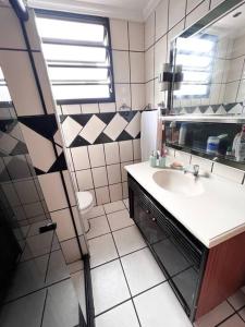 La salle de bains est pourvue d'un lavabo et d'un miroir. dans l'établissement Apartamento próximo da Praia, à Vila Velha