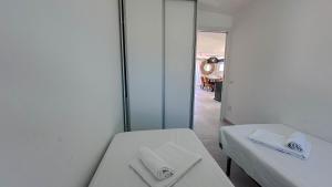 a room with two beds and a mirror at Casa Luna Blanca in Cala Gonone