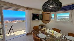 a dining room with a table and a view of the ocean at Casa Luna Blanca in Cala Gonone