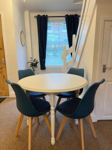 a table and chairs in a room with a window at City Of Chester Award Winning Cottage -Pixie Terrace Chester in Chester