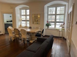 a living room with a table and chairs at Schloß Hürbel Rosengarten - Suite in Gutenzell-Hürbel