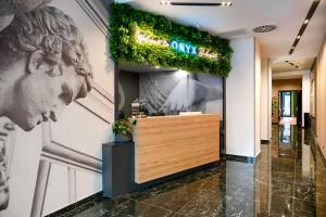 a lobby with a sign on a wall with a statue at Onyx Luxury Budapest in Budapest +108 photos
