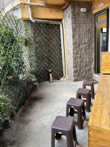 a group of stools sitting outside of a building at Apple cozy hotel in Tbilisi City