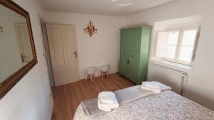 a bedroom with a bed and a green cabinet at Antico Chalet Mini Momosa in Ovindoli