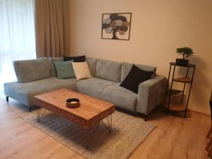 a living room with a couch and a coffee table at Tále Apartmán E2 - Evergreen Tále in Tale