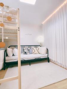a bedroom with a bunk bed with white pillows at Easel House in Seoul