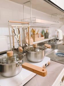 a kitchen with pots and pans on a counter at Easel House in Seoul