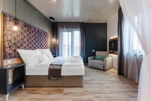 a bedroom with a large bed and a chair in it at Onyx Luxury Budapest in Budapest