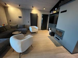 sala de estar con sofá y TV en Gudbrandsdalen view cabin, en Strande