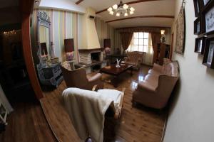 a living room filled with furniture and a mirror at Bamba House Cusco in Cusco