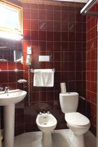 ein Bad mit einem WC und einem Waschbecken in der Unterkunft Au Nouvel Hôtel in Toulon