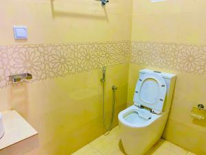 a bathroom with a toilet and a shower at New Heaven in Ambalangoda