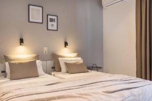 a bedroom with a large white bed with two pillows at Ciel Comfort Living in Laganas