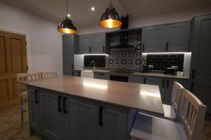 a kitchen with a large island in the middle at Red Lion Apartments in Spalding