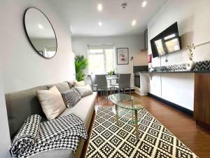 a living room with a couch and a table at 2 Bed- Camden Town in London