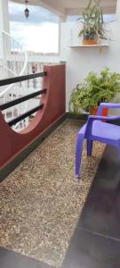 a blue chair sitting on a floor next to a staircase at Appartement LiHeRo in Antananarivo