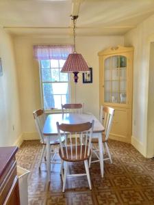 a dining room with a blue table and chairs at Moose Manor- Squam Waterfront in Holderness