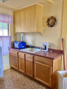 a kitchen with a sink and a counter top at Moose Manor- Squam Waterfront in Holderness