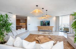 a living room with a couch and a tv at Spectacular Sea view Durban Presidential Penthouse in Durban