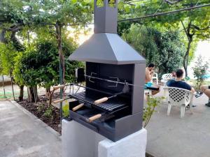 a outdoor grill with hot dogs on top of it at La Casona de Toledo in Gerindote