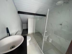 a bathroom with a shower and a sink and a toilet at Hospedagem ao lado do centro histórico in Paraty