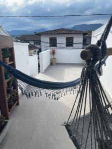 a hammock on the balcony of a house at Hospedagem ao lado do centro histórico in Paraty