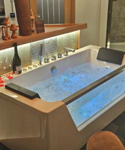 a bath tub filled with water in a room at Queen's Loft in Windermere
